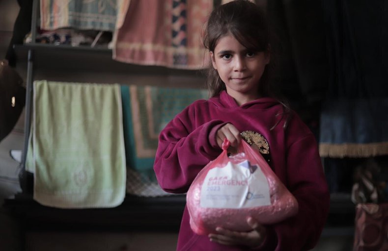 Child in Gaza with an aid parcel