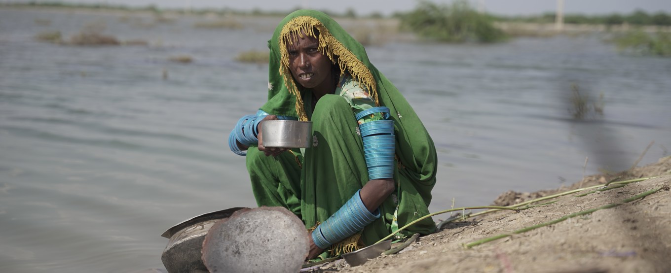 Pakistani woman collecting water from a lake